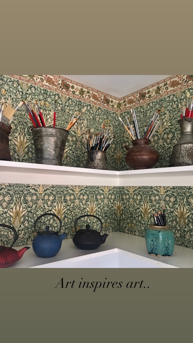 Paula Kuitenbrouwer's studio with WM wallpaper and vintage pots holding brushes